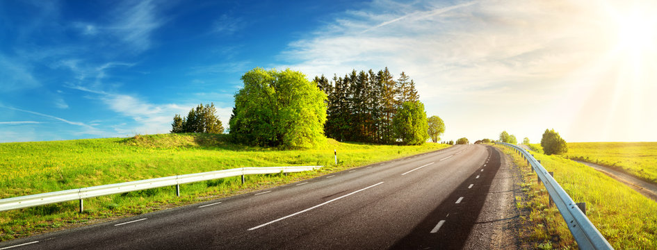 asphalt road panorama in countryside on sunny spring evening
