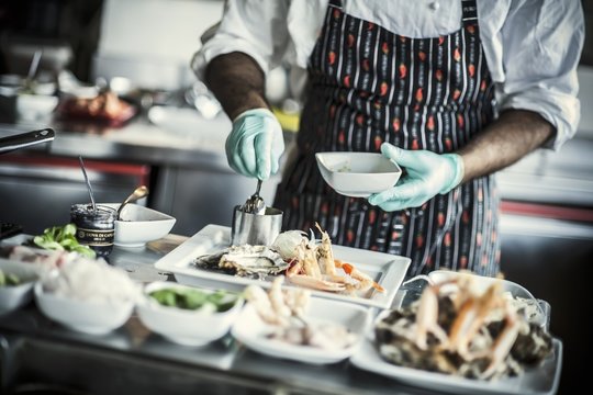 A chef arranging a plate of appetisers
