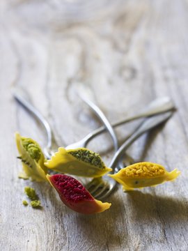 Ravioli with various fillings, skewered on forks