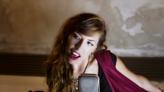 Portrait of beautiful woman in studio recording