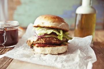 A bean veggie burger with smoked Cheddar and red onions in a brioche bun