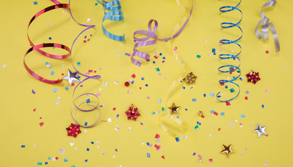 Red, yellow and green heart and circle confetti on a YELOW background. High resolution photo.