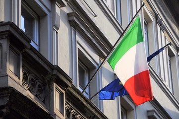 Italian and European flags on municipal building facade. - 137959746