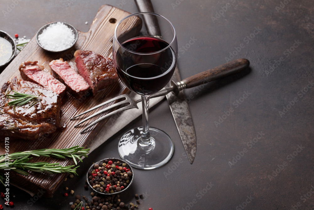 Wall mural grilled ribeye beef steak with red wine, herbs and spices