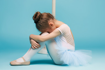 The little balerina dancer on blue background