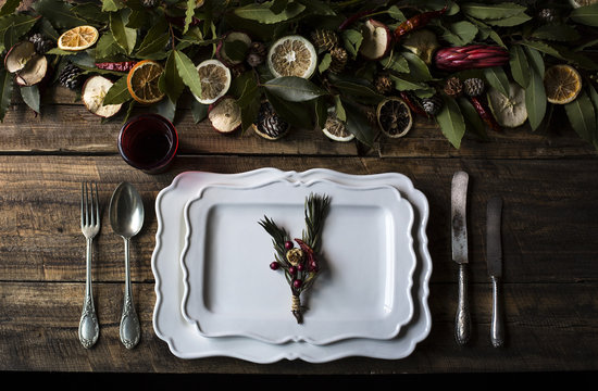Setting table with fruit and laurel leaves