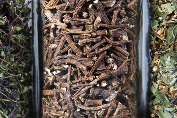 Dried dandelion roots herb inside a glass jar. Herbs and plants for tea.