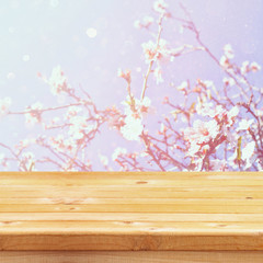 Naklejka na ściany i meble wooden table in front of spring cherry tree