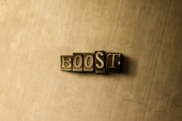 BOOST - close-up of grungy vintage typeset word on metal backdrop. Royalty free stock illustration.  Can be used for online banner ads and direct mail.