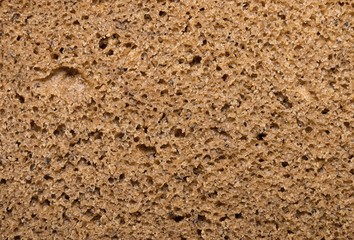 Brown bread, background texture. Macro shot.