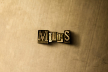 MILFS - close-up of grungy vintage typeset word on metal backdrop. Royalty free stock illustration.  Can be used for online banner ads and direct mail.