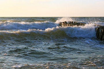 The waves of the Baltic Sea breaking on the old wooden german breakwater.