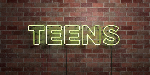 Fototapeta na wymiar TEENS - fluorescent Neon tube Sign on brickwork - Front view - 3D rendered royalty free stock picture. Can be used for online banner ads and direct mailers..