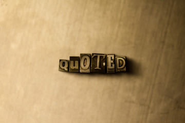 QUOTED - close-up of grungy vintage typeset word on metal backdrop. Royalty free stock illustration.  Can be used for online banner ads and direct mail.
