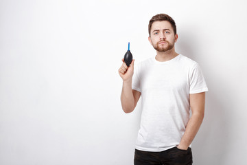 photographer holding camera cleaning vacuum pump.  air blower pu