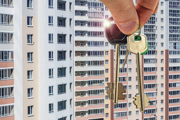 	The keys to the apartment in the background of a new residential homes . The concept of changes in...