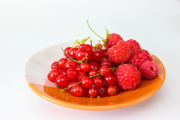 Berries red currants and raspberry on a plate