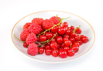 Berries red currant and raspberry on a plate