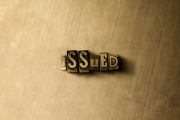 ISSUED - close-up of grungy vintage typeset word on metal backdrop. Royalty free stock illustration.  Can be used for online banner ads and direct mail.