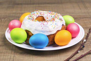 Festive table with colorful  eggs and  cupcake