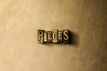 PIECES - close-up of grungy vintage typeset word on metal backdrop. Royalty free stock illustration.  Can be used for online banner ads and direct mail.