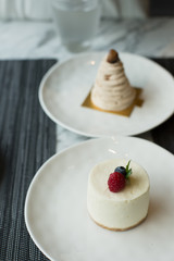 Plates of Cheesecake and Mont Blanc on Table in Restaurant