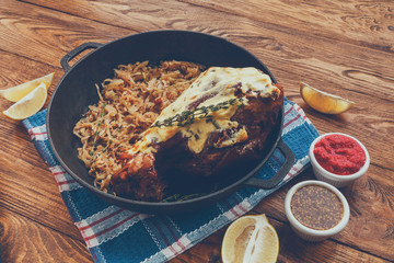 German restaurant food. Roasted pork leg with sauerkraut