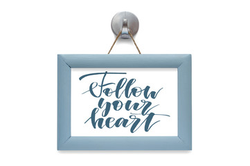Follow your heart - motivational quote. Stylized lettering. Blue wooden frame. Isolated