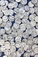 Vintage thirties silver shiny and dull quarters background. Vertical.