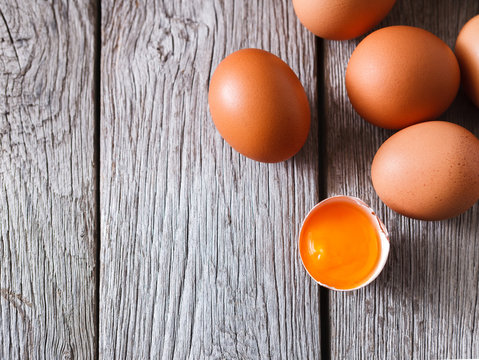 Fresh chicken brown eggs on rustic wood, organic farming concept background
