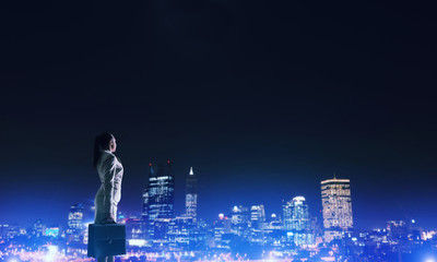 Woman looking at night city