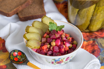 Russian salad boiled vegetables with carrots, beets, potatoes, peas, pickles and oil