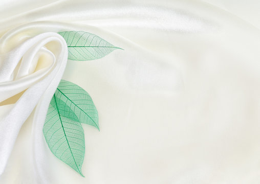White silk drapery with green leaves