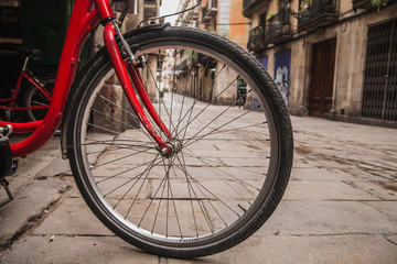Fototapeta na wymiar City view through bicycle wheel in Barcelona, Spain