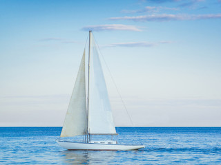 Obraz premium Sailing yacht with white sails in the open Sea. Blue water.
