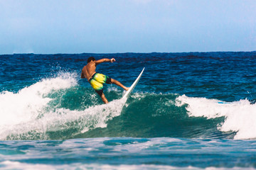 Male surfer riding the waves of the Atlantic Ocean