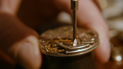 clockwork close up in the hands of a watchmaker