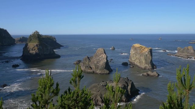 Very slow pan of Spruce Island from the Arch Rock viewpoint in Samuel H. Boardman State Scenic Corridor, southern Oregon coast; includes ambient audio.