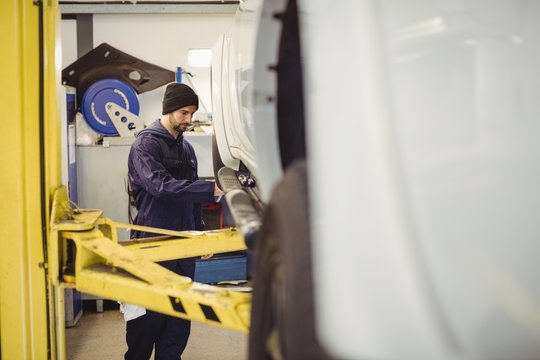 Mechanic examining a car