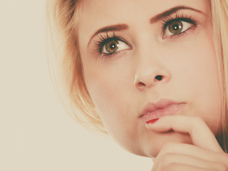 Attractive blonde woman thinking and contemplating