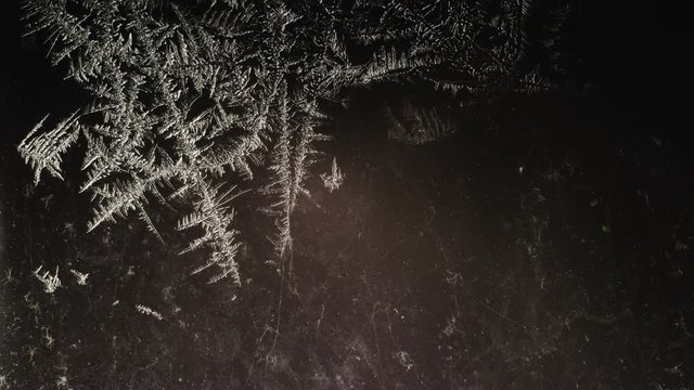 little frozen patterns disappear on dirty glass