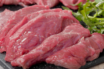 slice of raw beef with salad