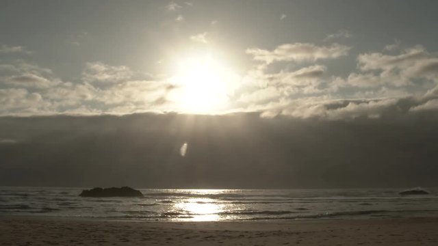 Time lapse of large cloud bank over the Pacific Ocean moving toward mainland off the Oregon Coast near sunset.