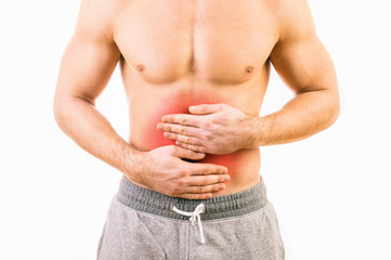 Naklejka premium Man with stomach pain over white background