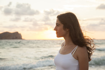 Fototapeta na wymiar romantic woman feelling free on a sunset beach in Ibiza