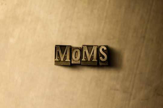 MOMS - close-up of grungy vintage typeset word on metal backdrop. Royalty free stock illustration.  Can be used for online banner ads and direct mail.