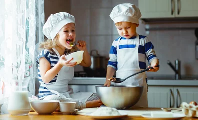 Poster happy family funny kids bake cookies in kitchen © JenkoAtaman