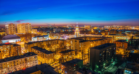 Night cityscape of Voronezh, view from rooftop of skyscraper, Tower in architecture Stalinist empire with star illuminated by colored lights