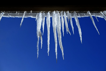 Icicles Hanging from Rooftop of Home Melted Ice Dripping