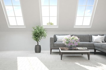 White room with sofa and green landscape in window. Scandinavian interior design